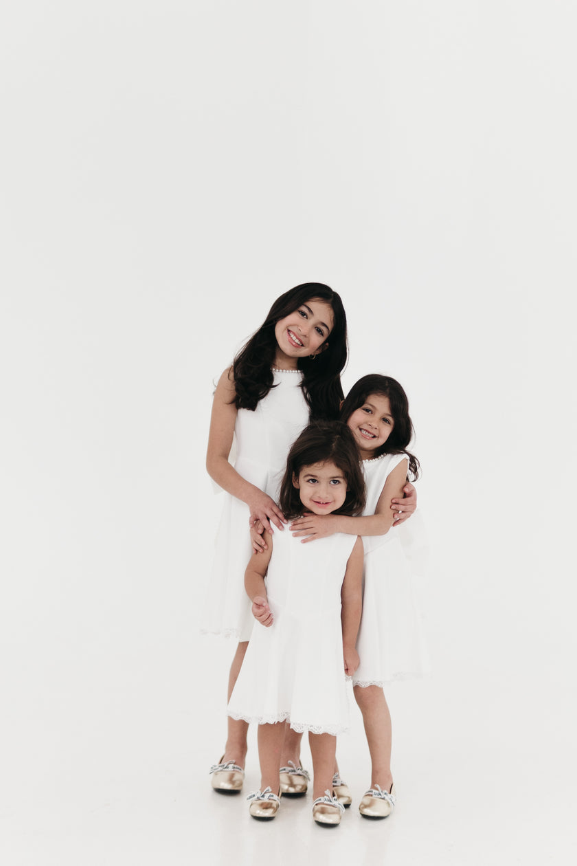 Girls pearl trimmed bow back mini dress