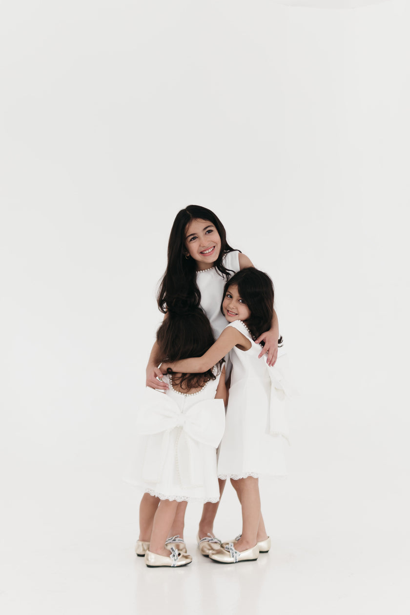 Girls pearl trimmed bow back mini dress