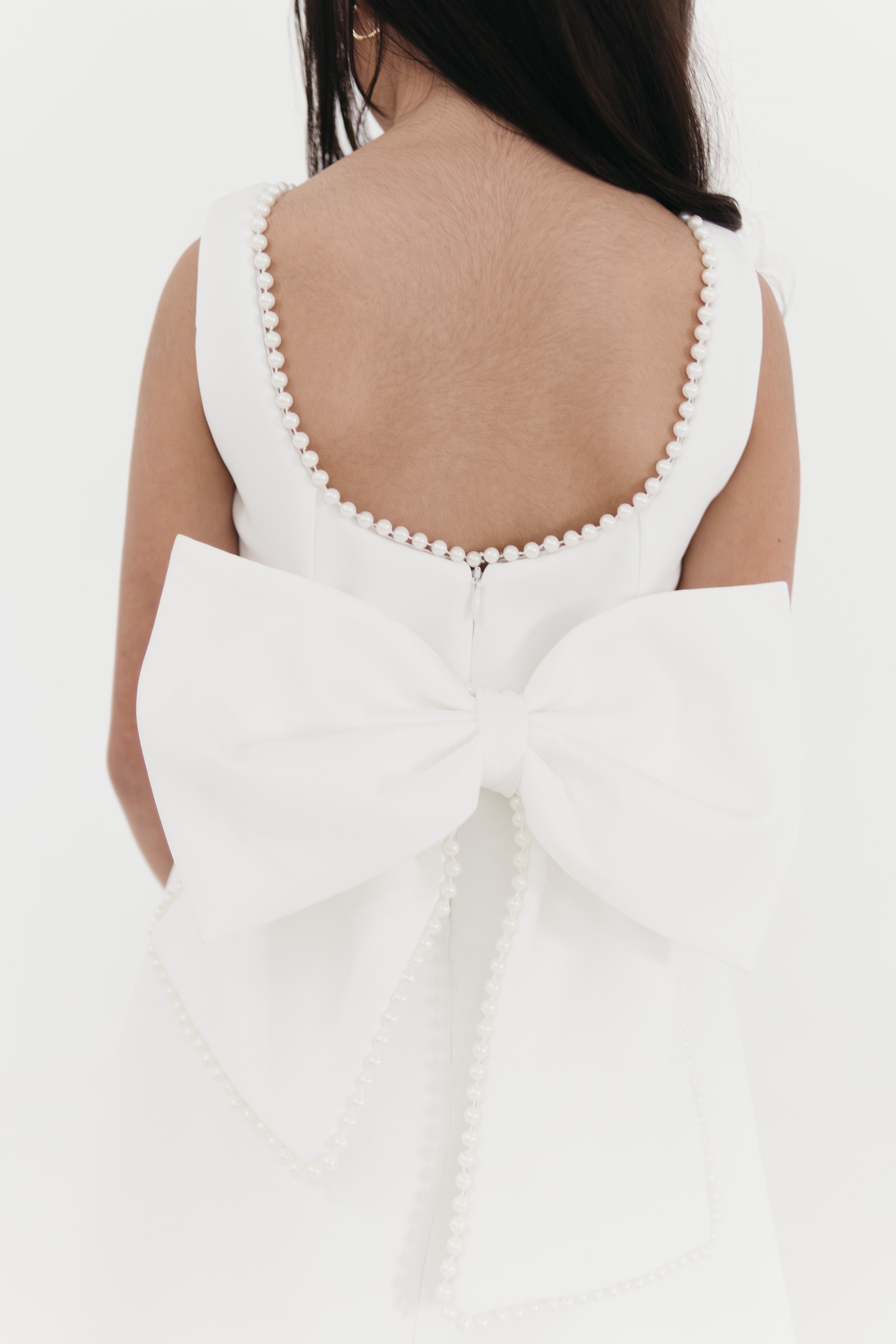 Girls pearl trimmed bow back mini dress