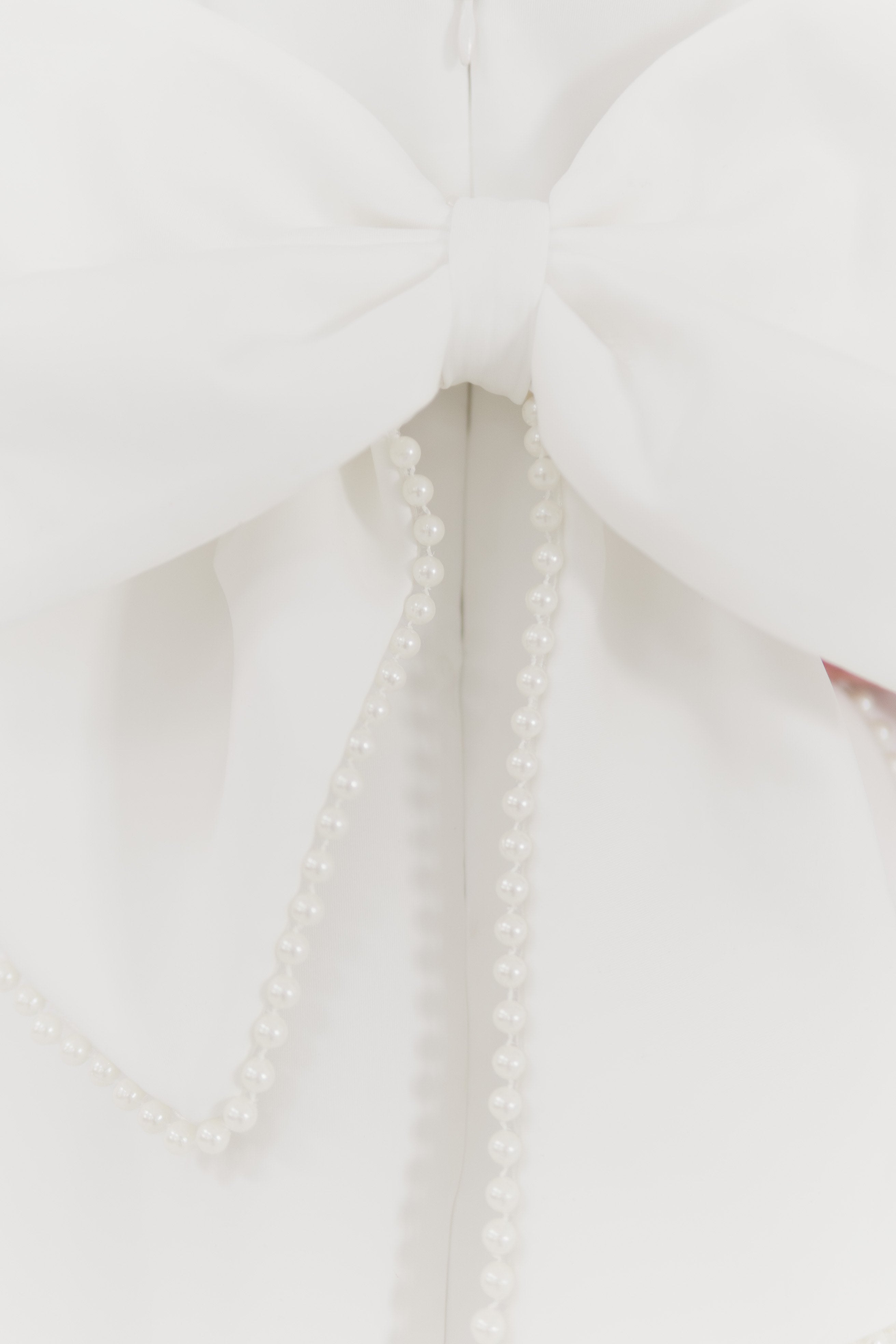 Girls pearl trimmed bow back mini dress