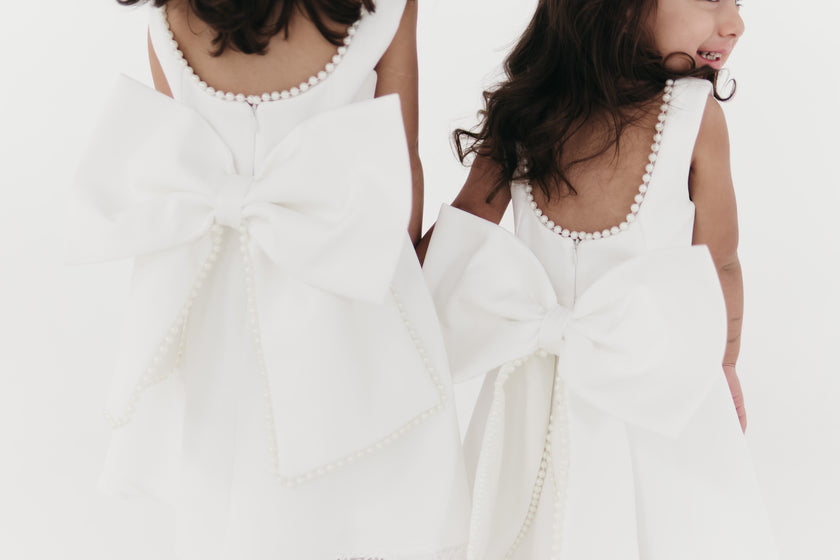 Girls pearl trimmed bow back mini dress